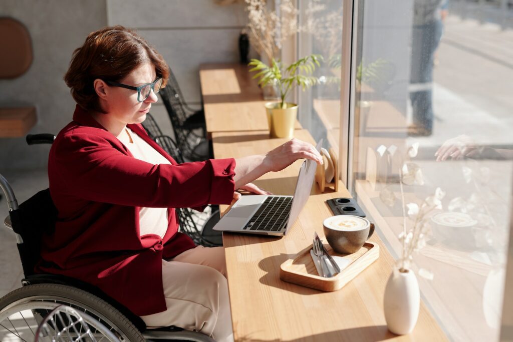 woman in wheelchair at desk working